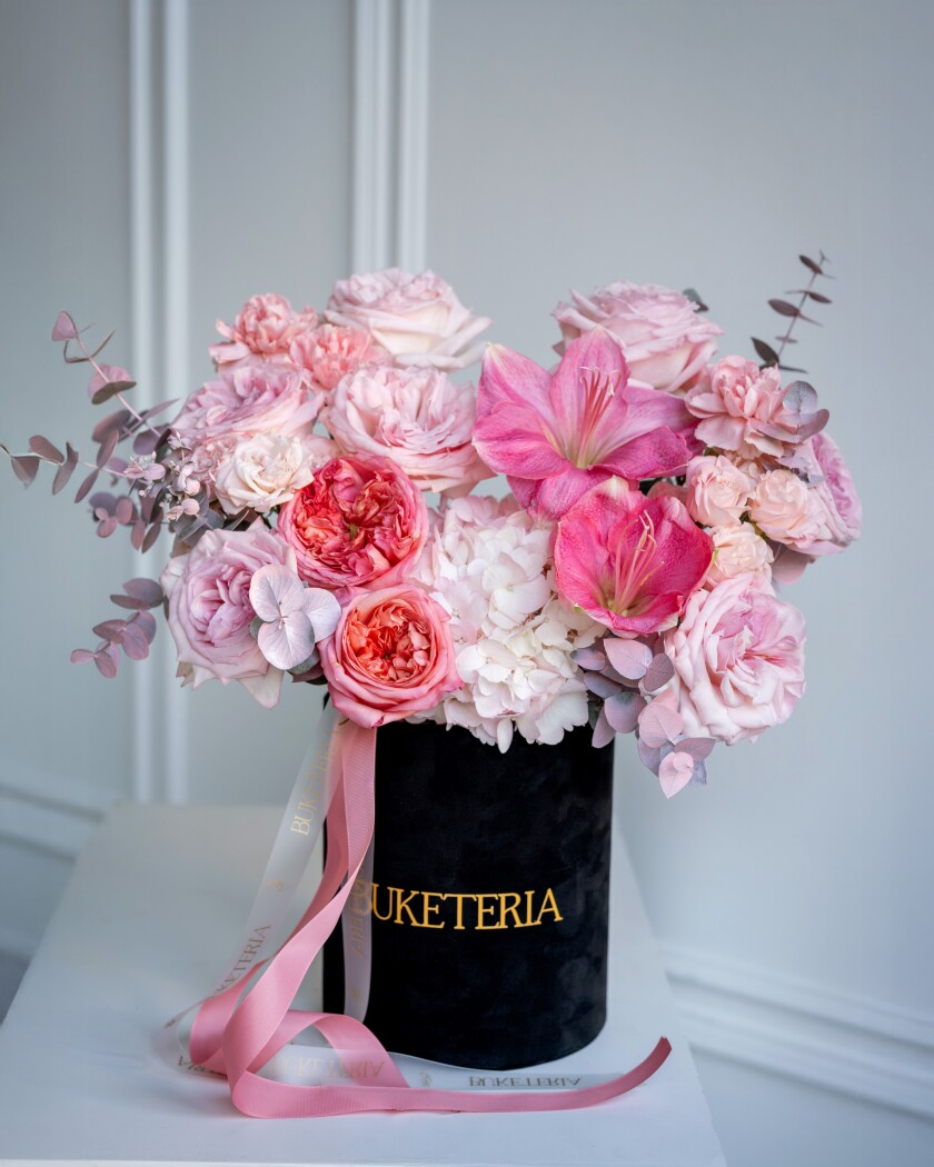 Seven light pink garden roses with peach and hot pink accents