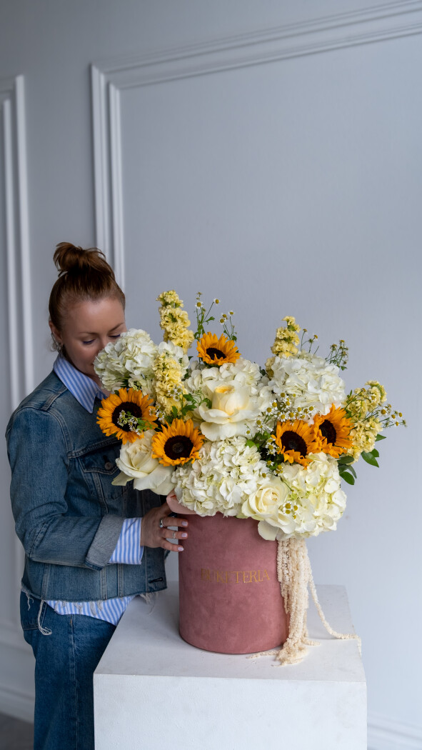 Decorative composition of white hydrangeas and yellow sunflowers