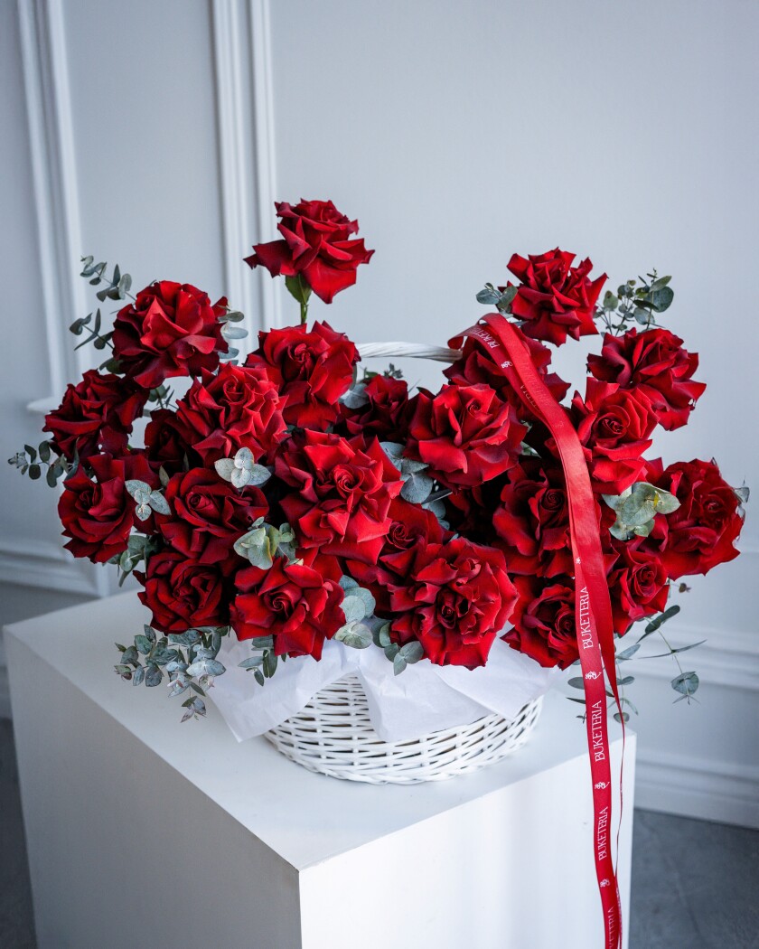 Twenty-five red hybrid tea roses in a basket