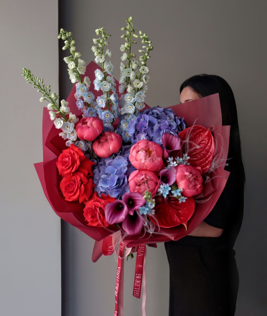 Mixed bouquet of pink peonies and lavender delphiniums