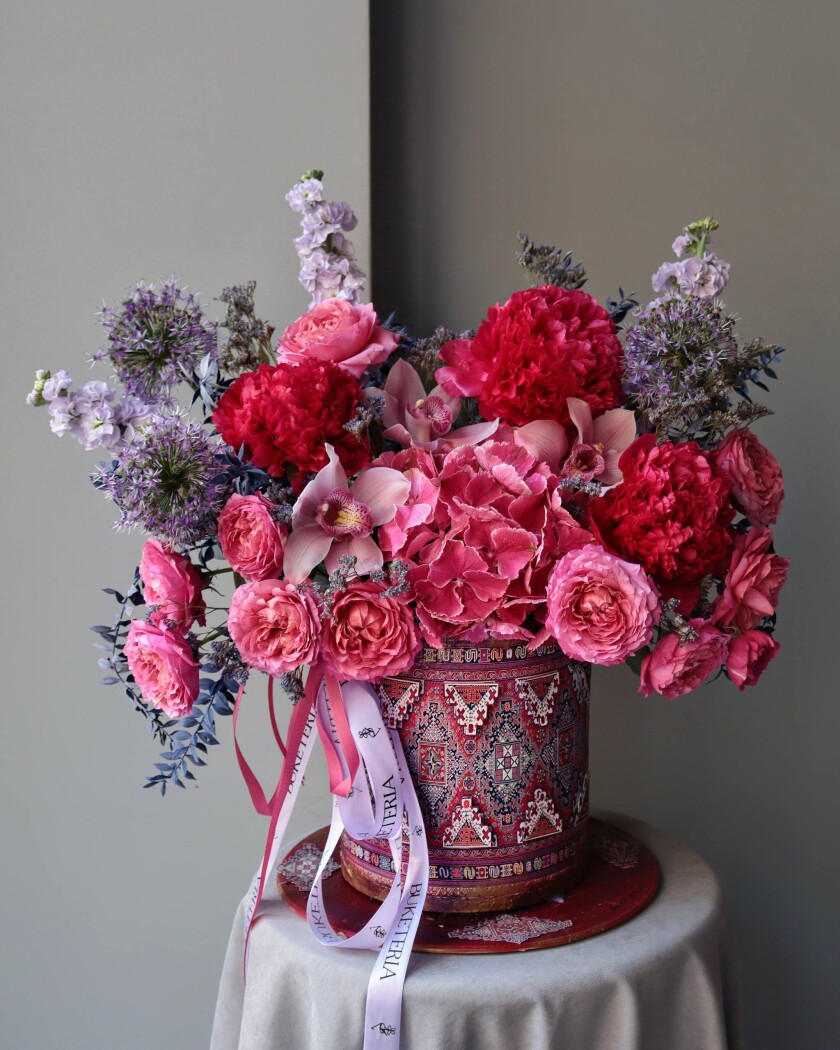 Four spray roses with peonies and standard alliums in an art composition