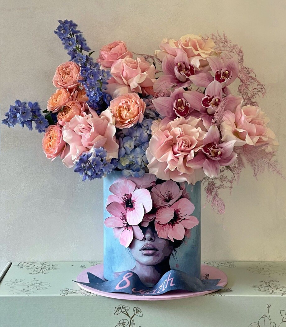 Decorative composition of peach garden roses and blue delphiniums