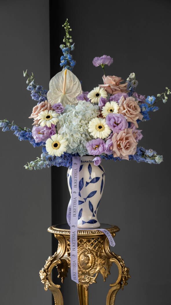 Light blue delphiniums with peach garden roses