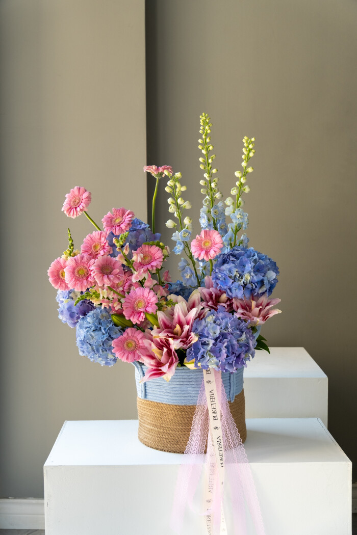 Blue hydrangeas with light pink gerberas and delphiniums