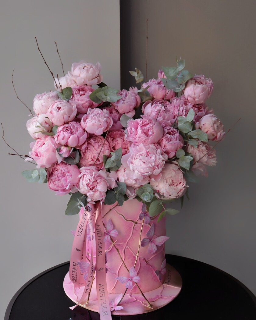 Decorative composition of pink peonies in an art box