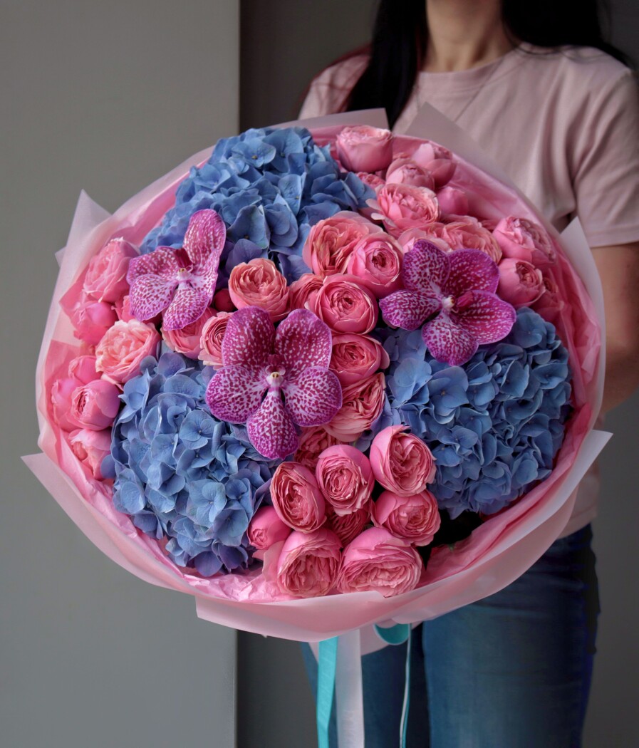 Mixed bouquet of pink spray roses, purple vanda orchids, and blue hydrangeas
