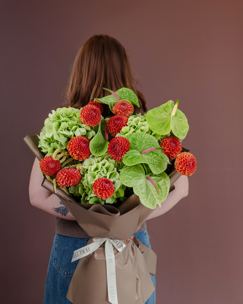 Red anthuriums with coral dahlias and green hydrangeas
