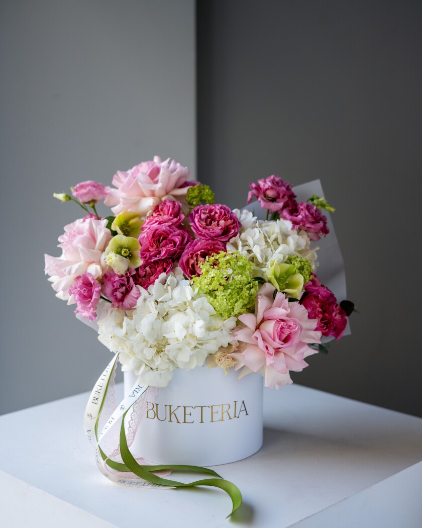 Decorative composition of white hydrangeas and pink lisianthus