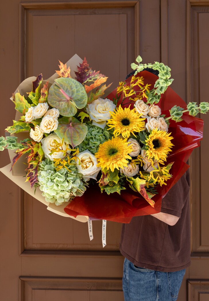Two green hydrangeas with yellow sunflowers and dusty pink roses