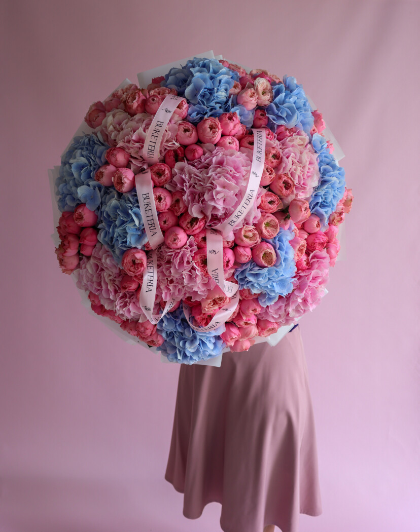 Mixed bouquet of blue and pink hydrangeas with pink spray roses
