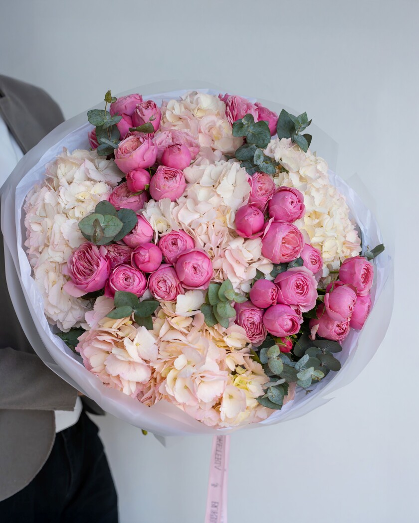 Ten hot pink spray roses with cream hydrangeas