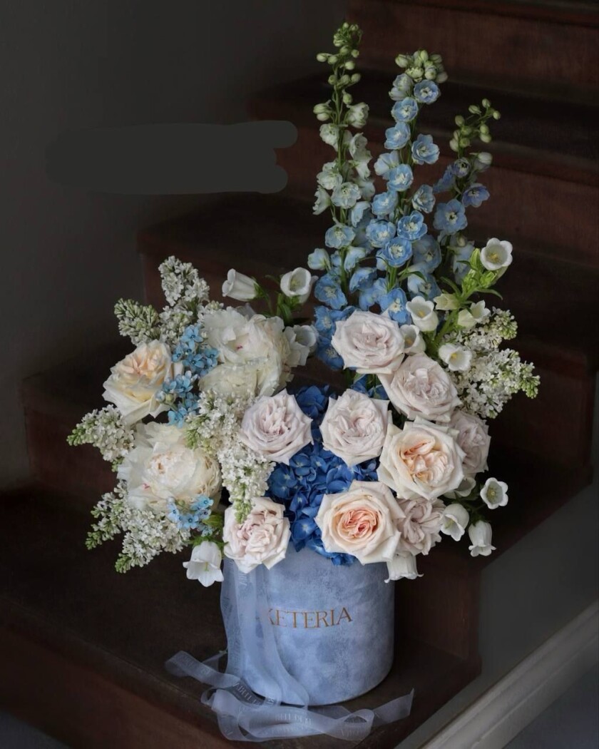 Blush garden roses with light blue delphiniums and lilacs