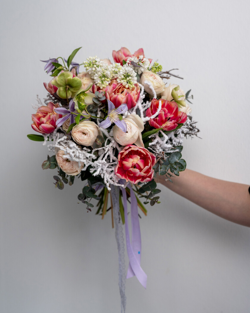 Seven red double tulips and three peach spray roses