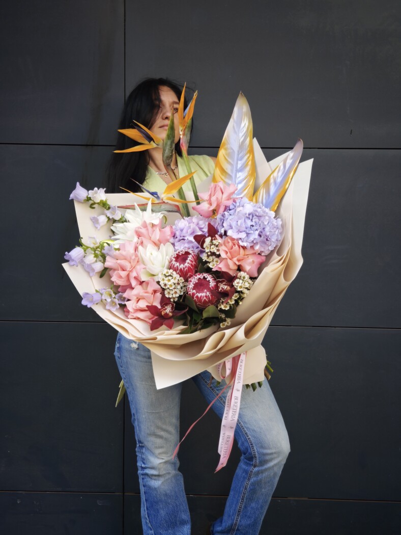 Mixed bouquet of burgundy proteas and orange strelitzia