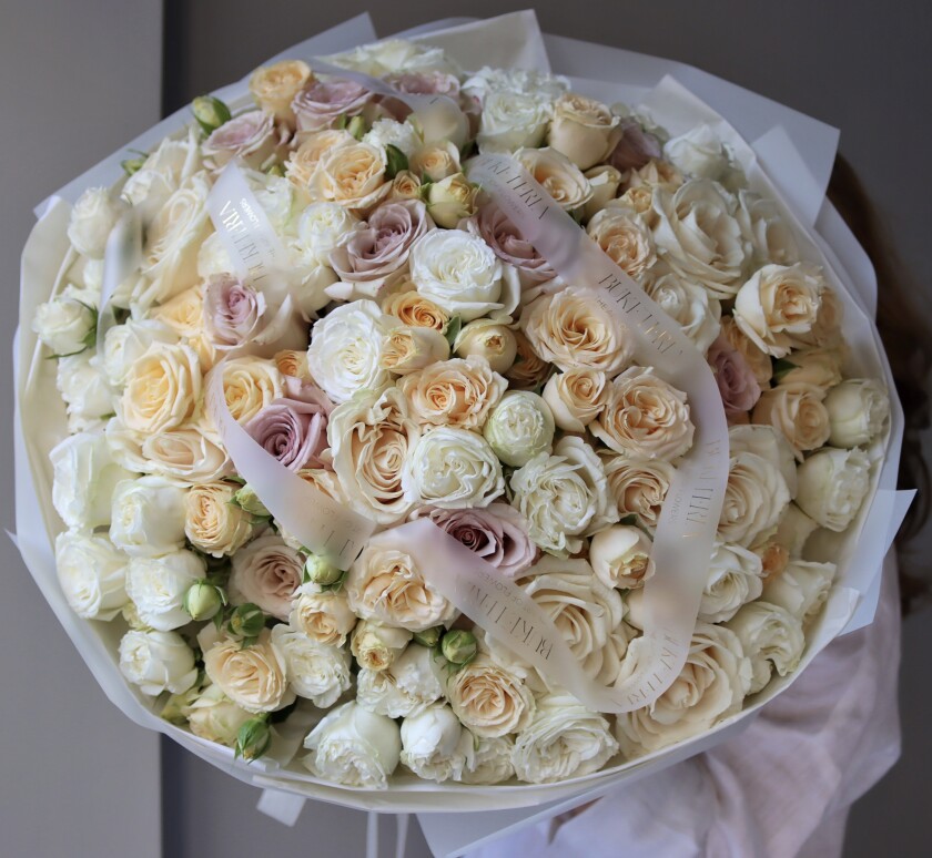 Peach and cream roses in a round mono bouquet