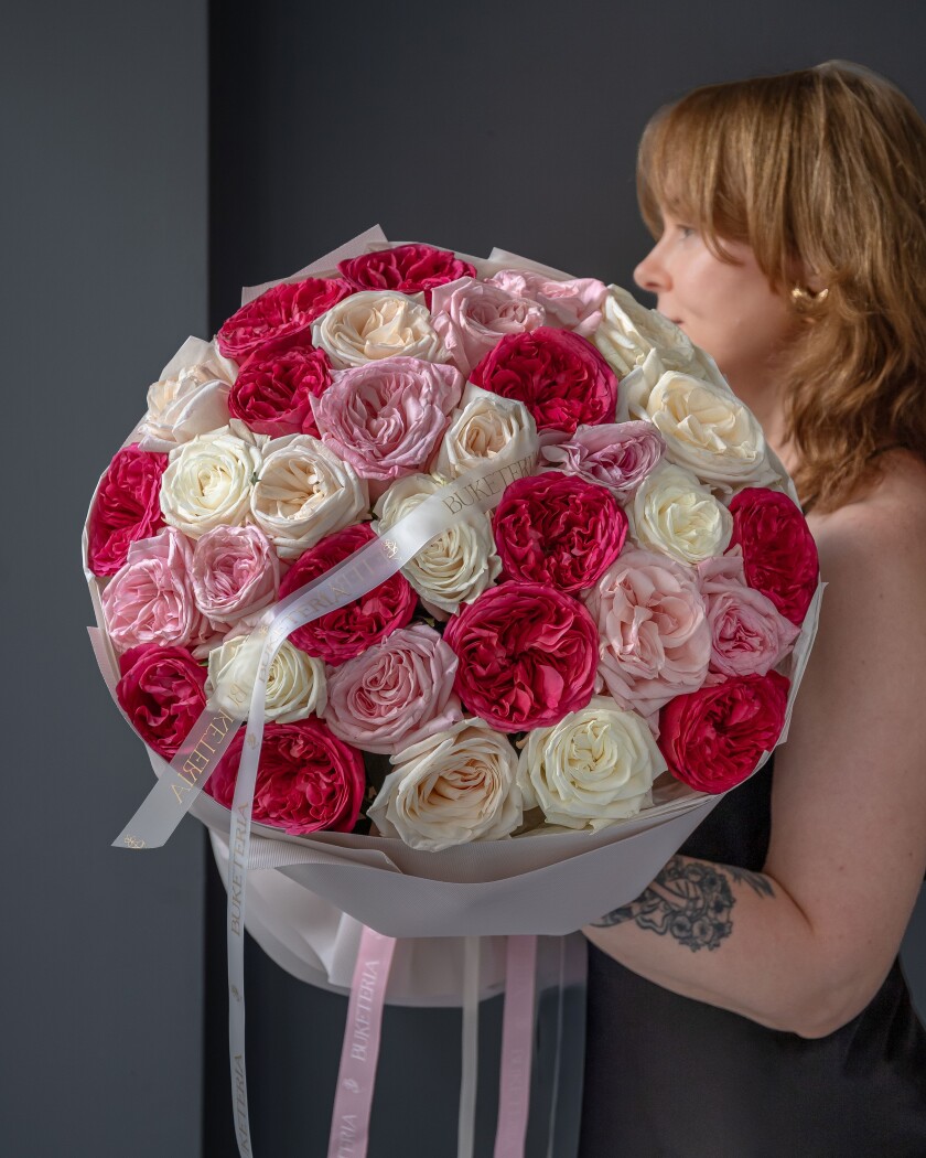 Twelve blush garden roses with pink and white accents