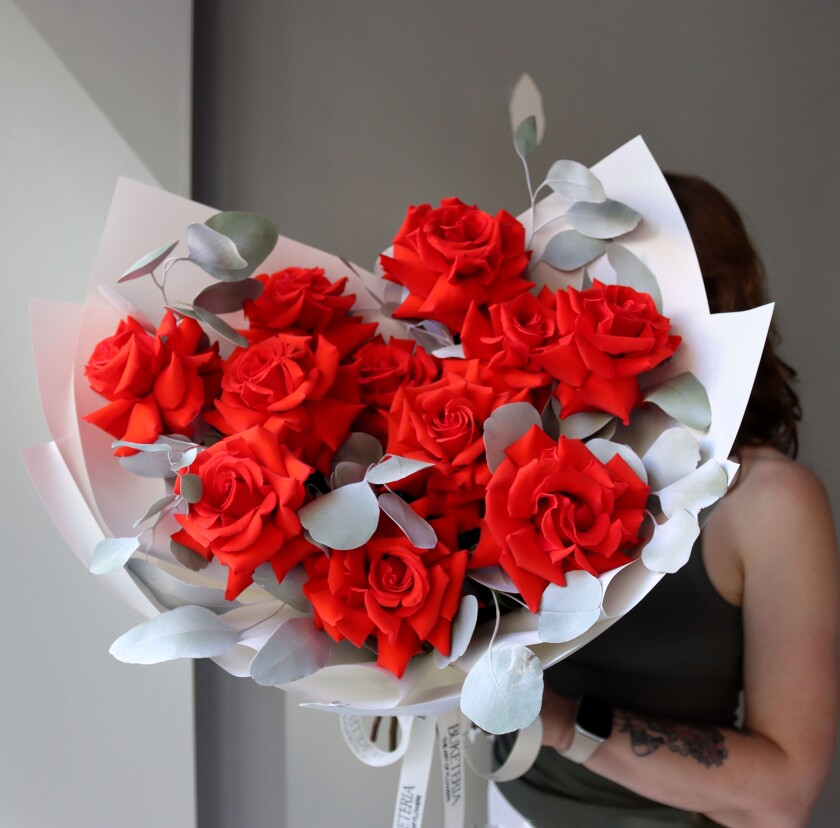 Eleven red hybrid tea roses in waterproof paper
