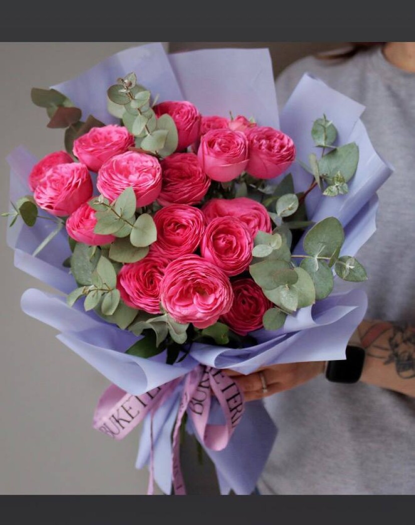 Three hot pink spray roses in waterproof paper