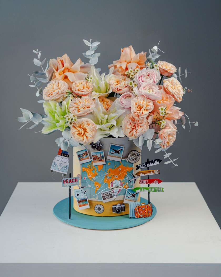 Decorative composition of light pink ranunculus and apricot garden roses