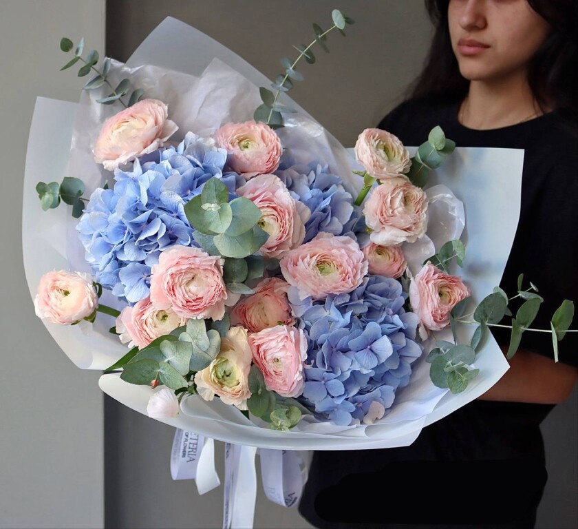 Blush ranunculus and light blue hydrangea bouquet