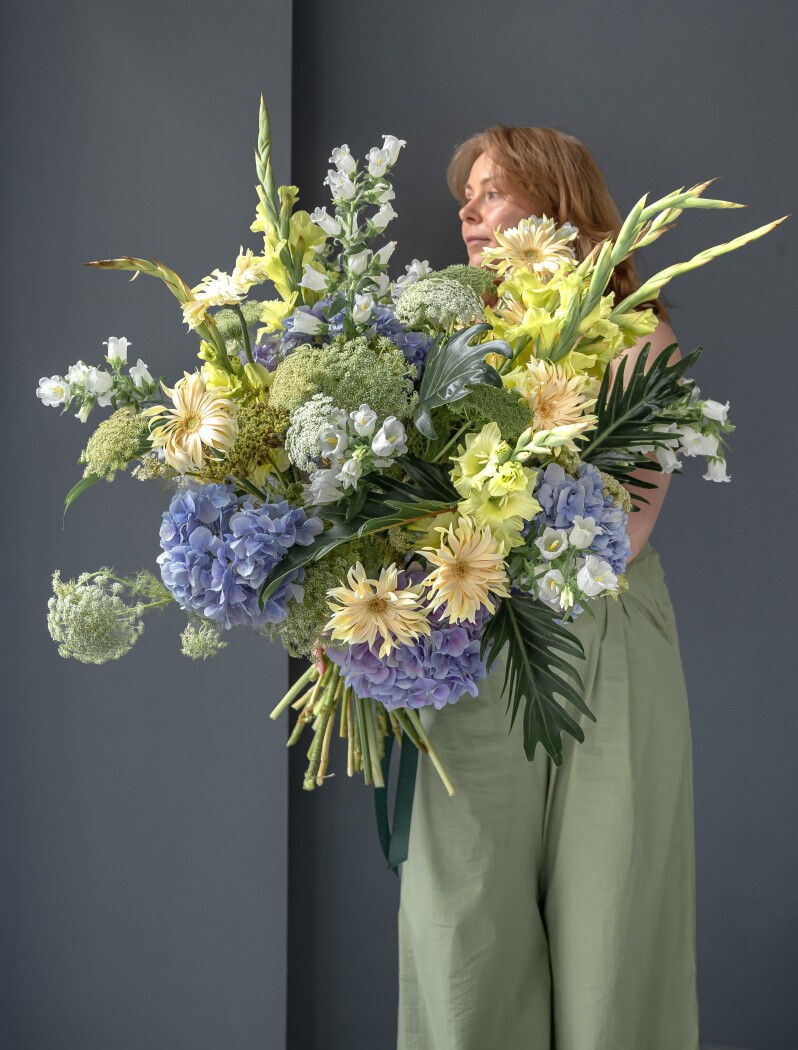 Blue hydrangeas with yellow gladiolus and cream gerberas