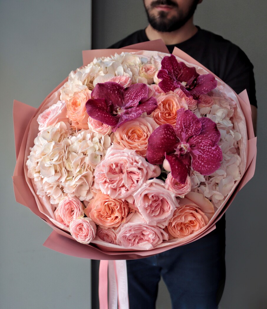 Seven blush garden roses with peach garden roses and white hydrangeas