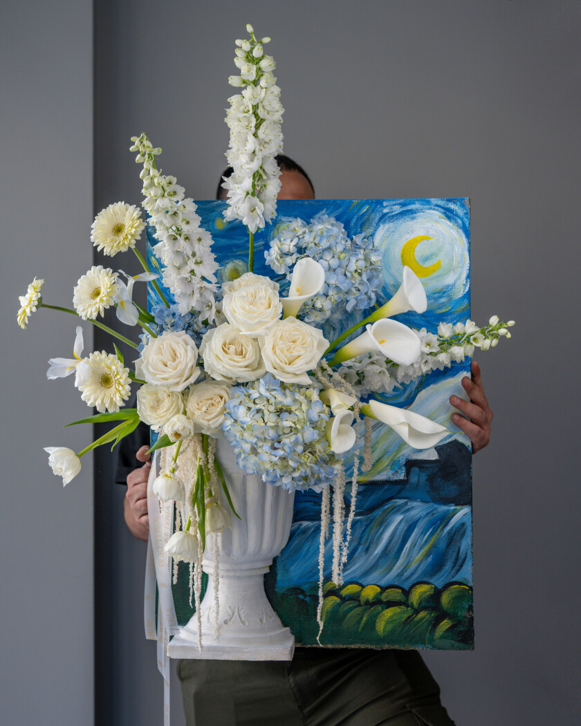 Elegant composition of blue hydrangeas and cream roses