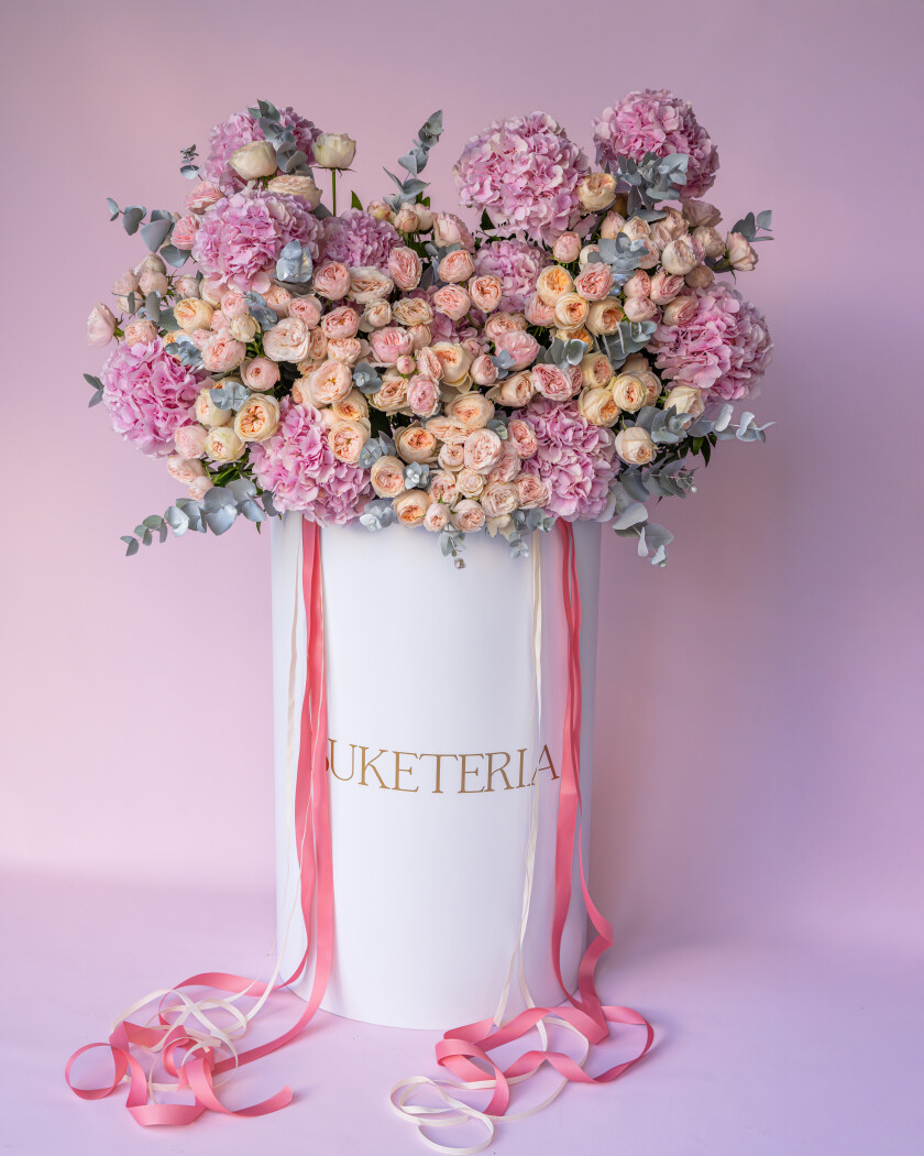 Blush spray roses and pink hydrangeas in a decorative arrangement