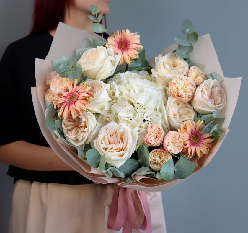 Seven dusty pink garden roses with peach spray roses and coral gerberas