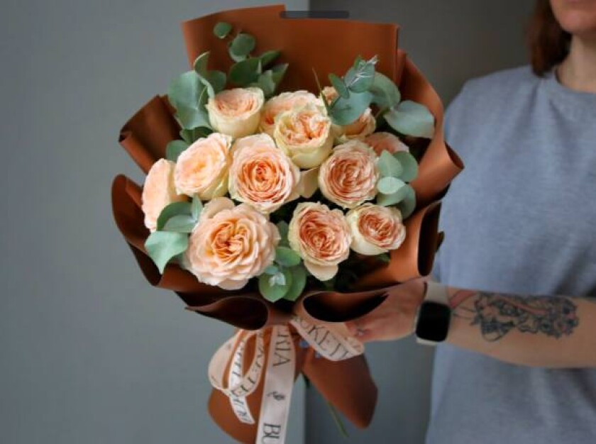 Peach spray roses with silver dollar eucalyptus