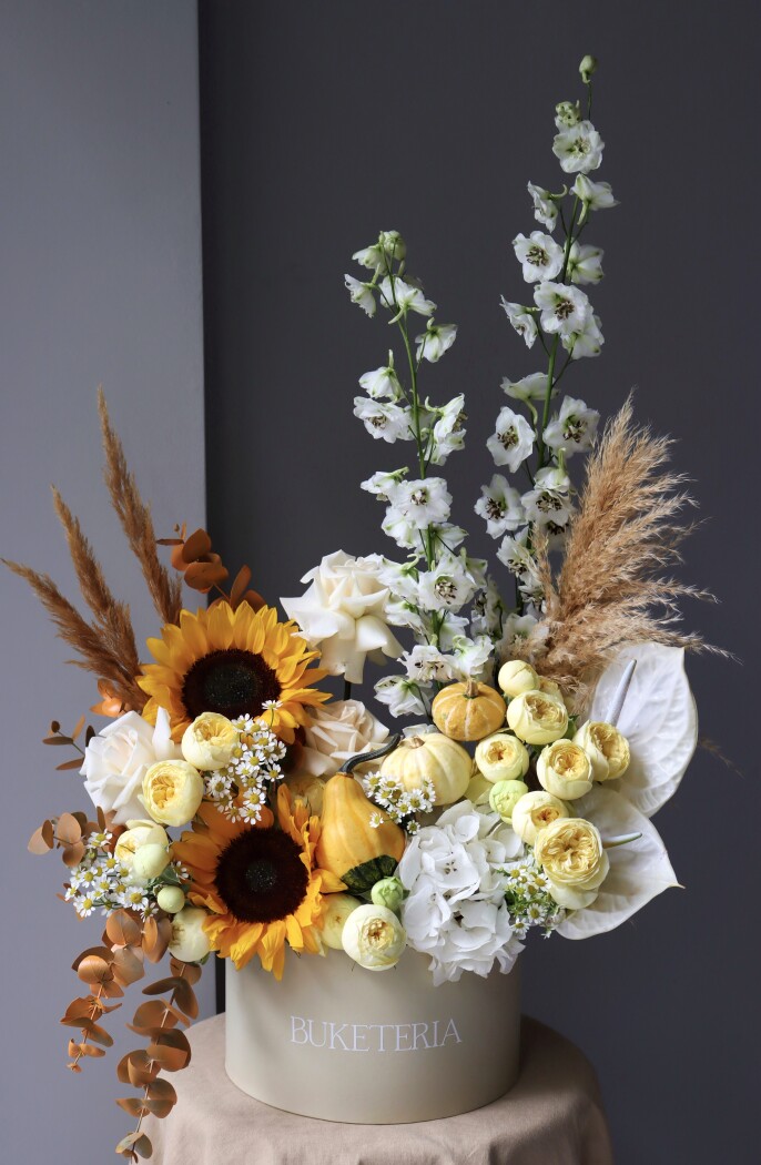 Cream spray roses with yellow sunflowers and red anthuriums