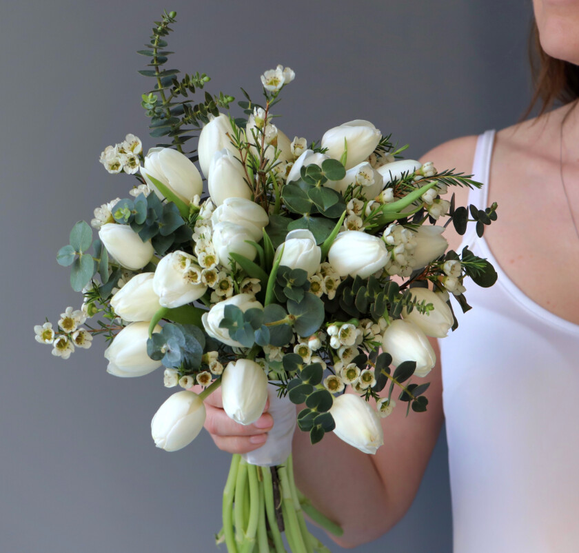 Twenty-seven white tulips with baby blue eucalyptus