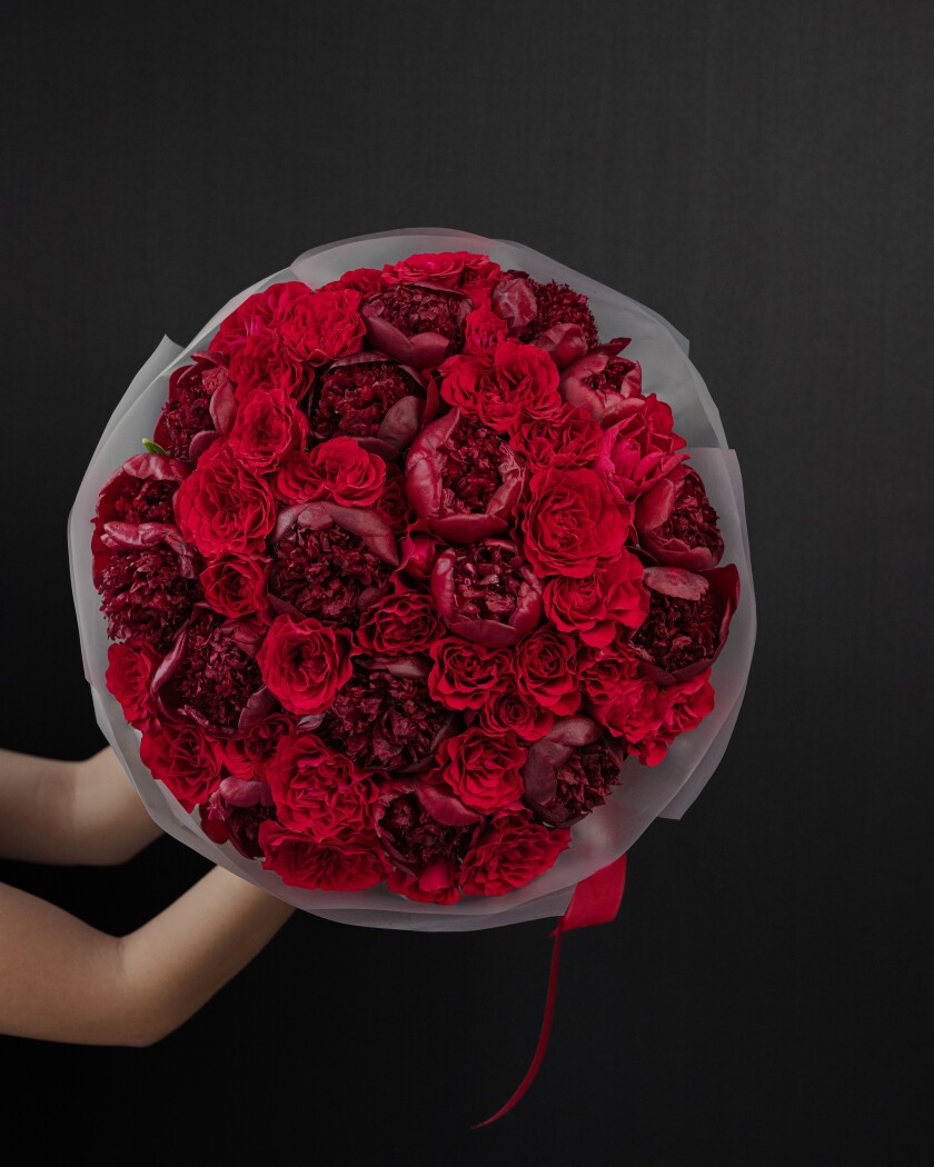 Burgundy peonies and red spray roses