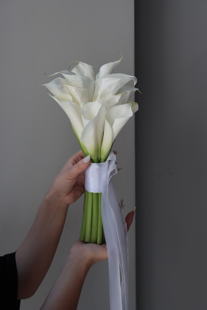 Fifteen white callas in a classic hand-tied bouquet