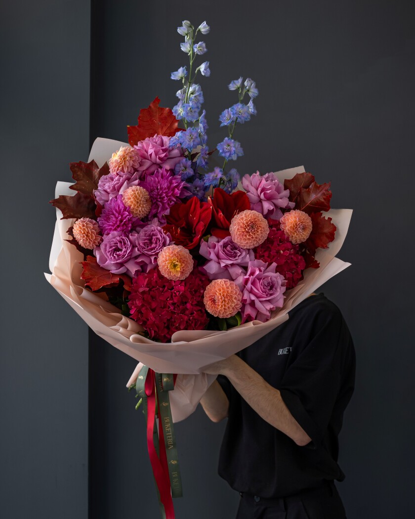 Coral ball dahlias with red hydrangeas and mauve garden roses