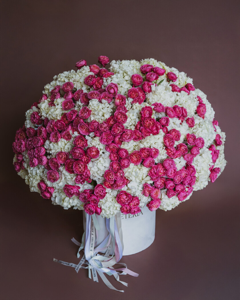 Decorative composition of white hydrangeas and hot pink spray roses