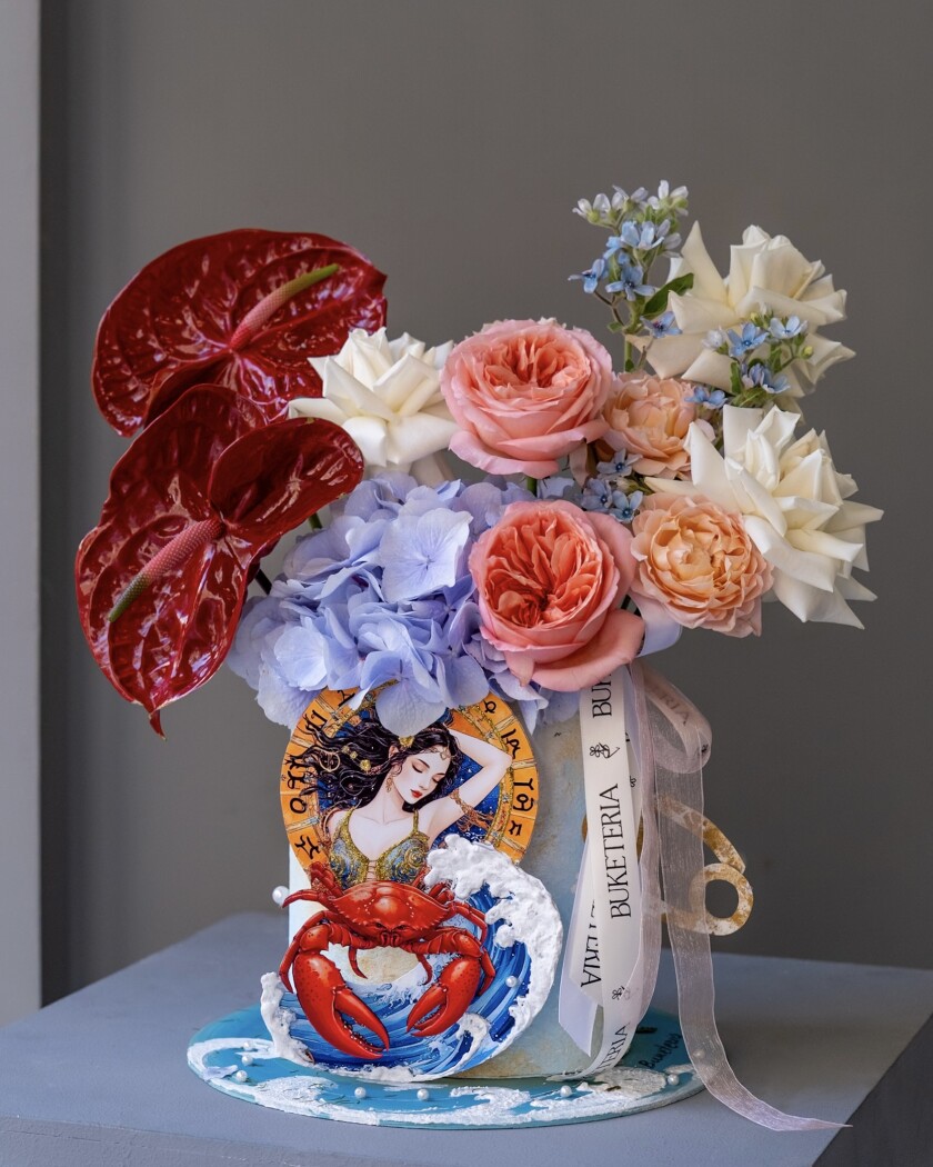 Decorative composition of red anthuriums and light blue tweedia