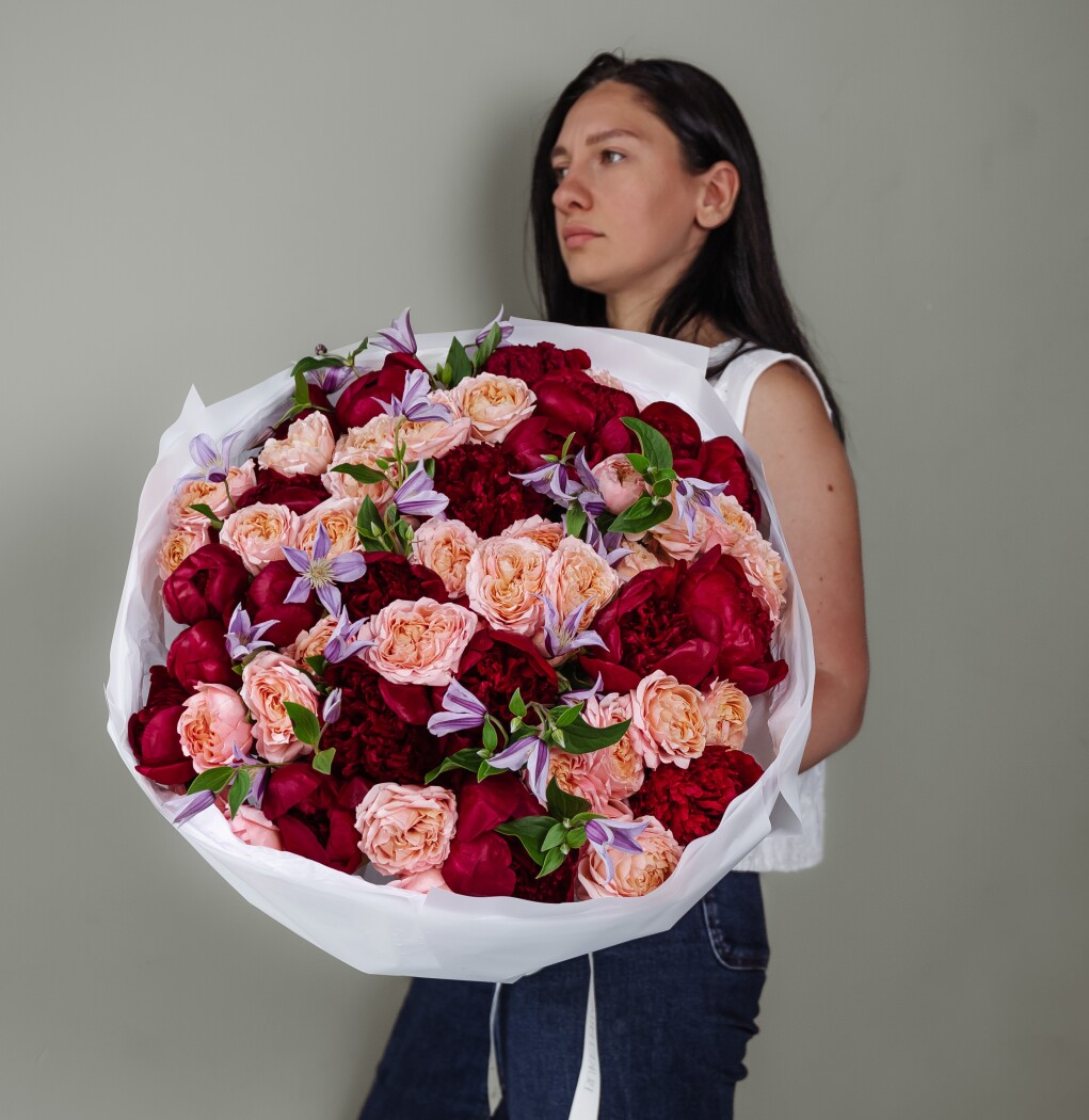 Burgundy peonies with peach spray roses and lavender clematis