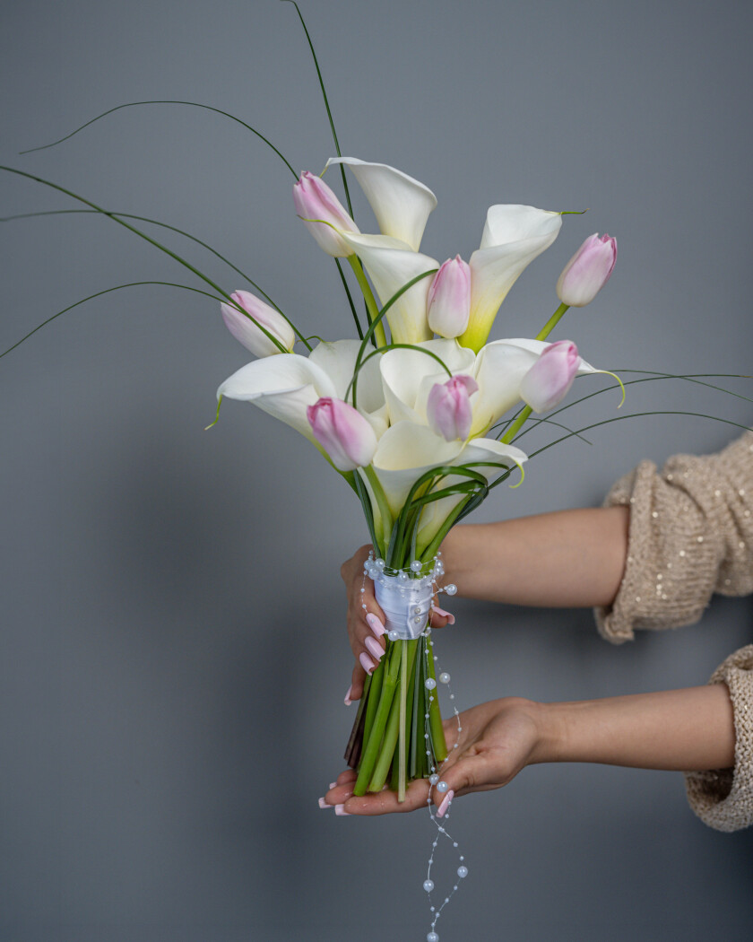 Nine white callas and seven light pink tulips