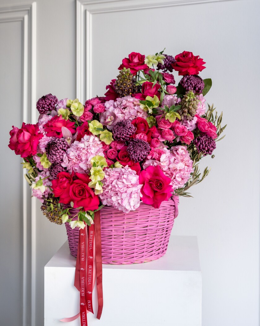 Decorative arrangement of blush hydrangeas and red garden roses
