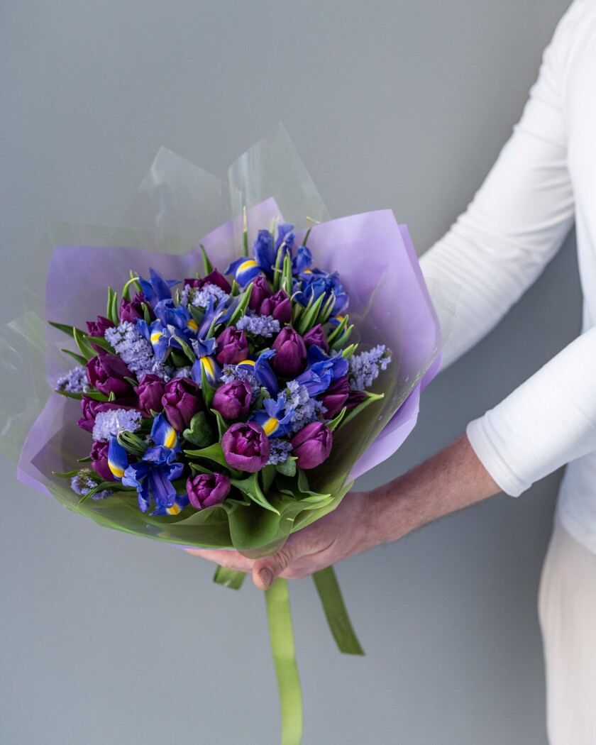 Purple tulips and blue dutch irises in a modern bouquet
