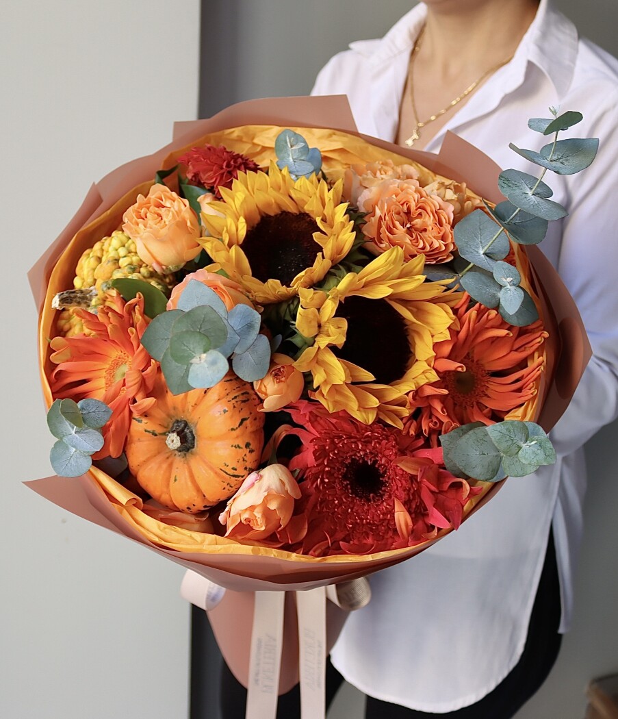 Mixed bouquet of orange gerberas, yellow sunflowers, and red dahlia