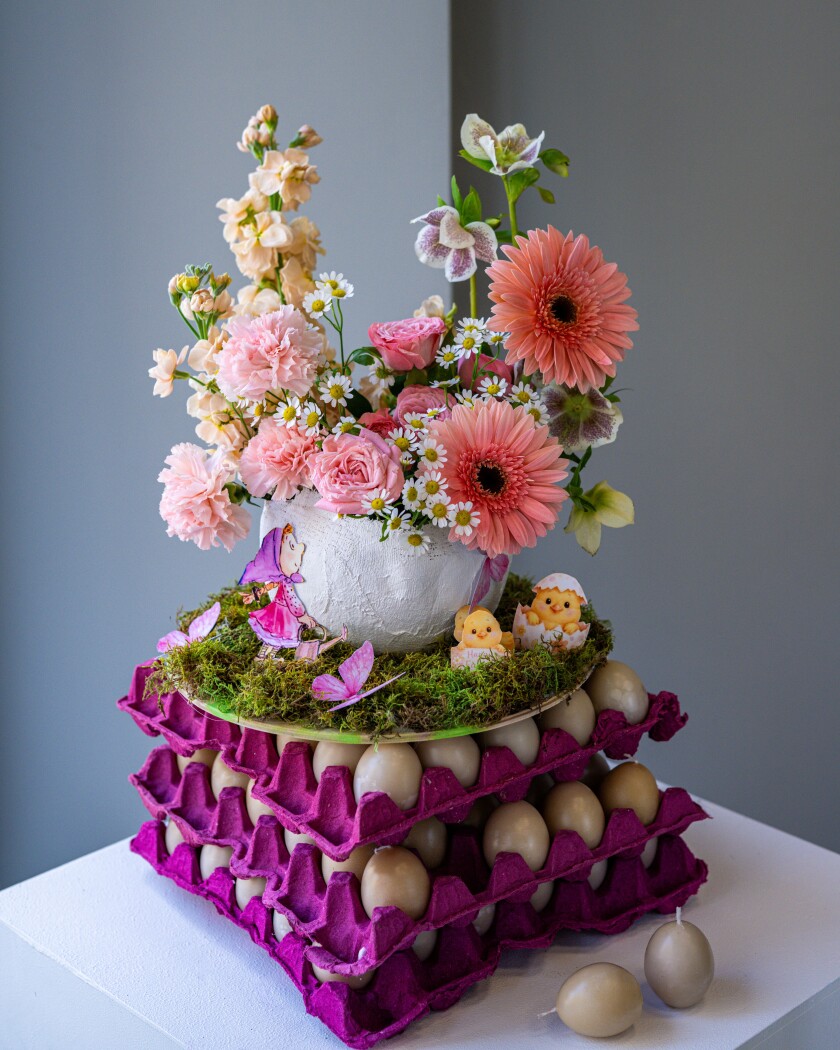 Decorative arrangement of white hellebores and light pink carnations