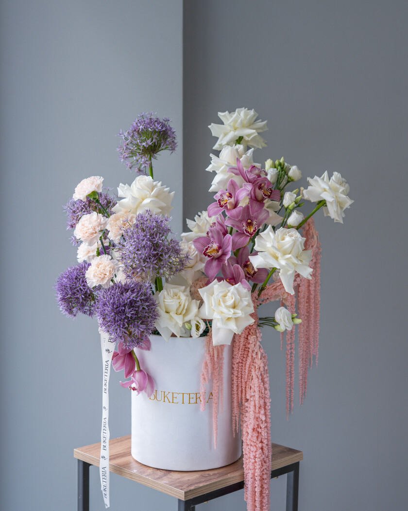 White roses with pink cymbidium orchids and purple alliums