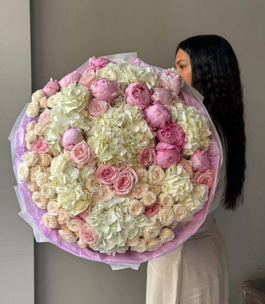 Sixteen pink spray roses with peonies and white hydrangeas