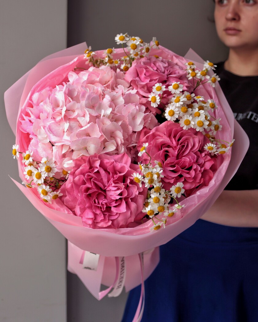 Three dusty pink garden roses and one pink hydrangea