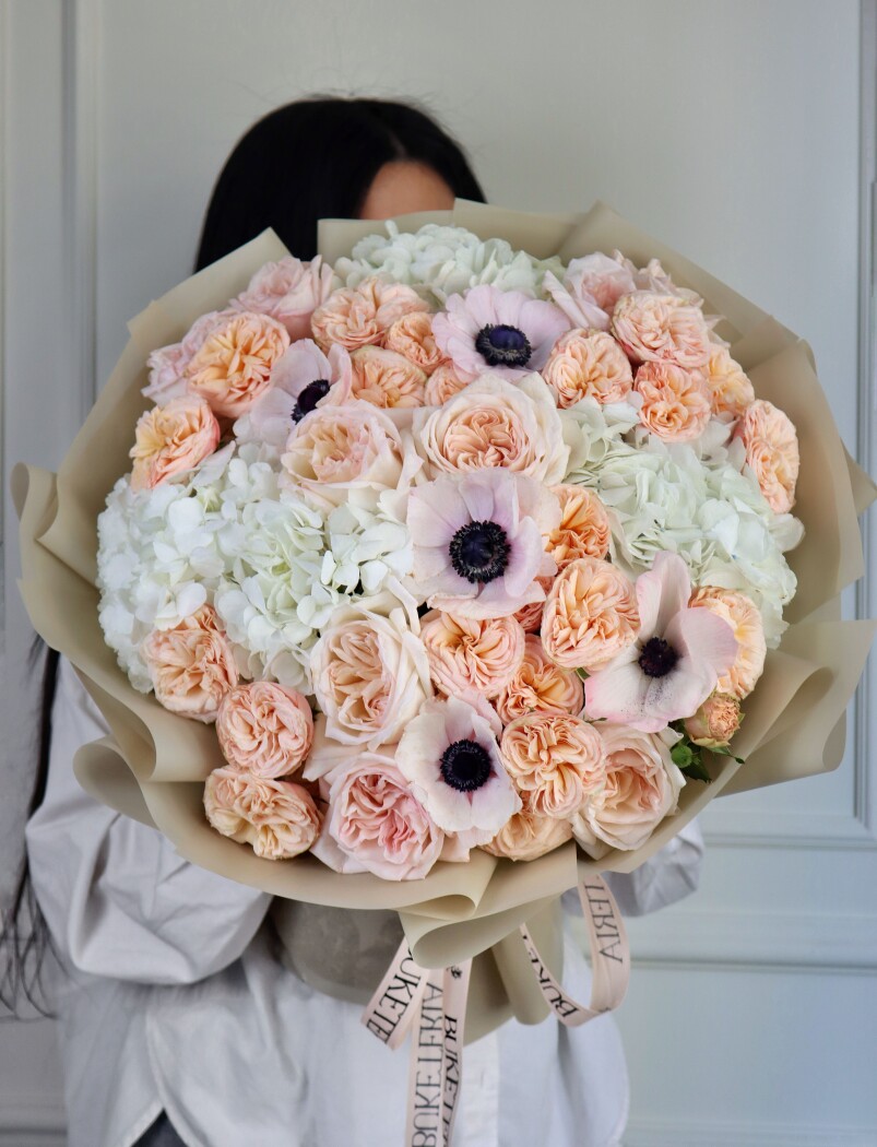 Nine dusty pink garden roses with peach spray roses