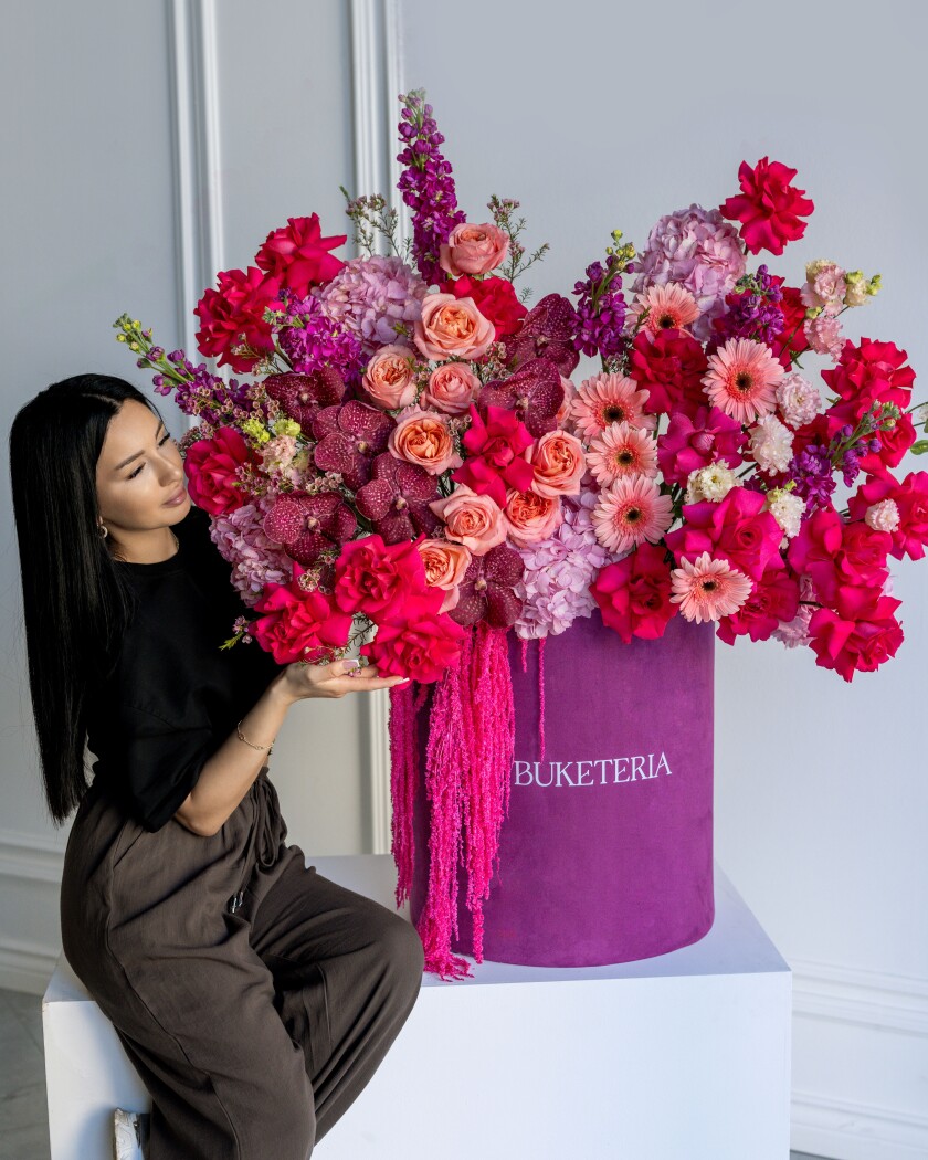 Twenty-five deep pink garden roses with peach roses and hydrangeas