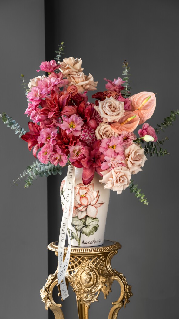 Cream garden roses with coral anthuriums and pink lisianthus