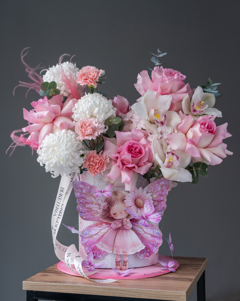 Decorative composition of five blush garden roses with white hydrangea and cymbidium orchids